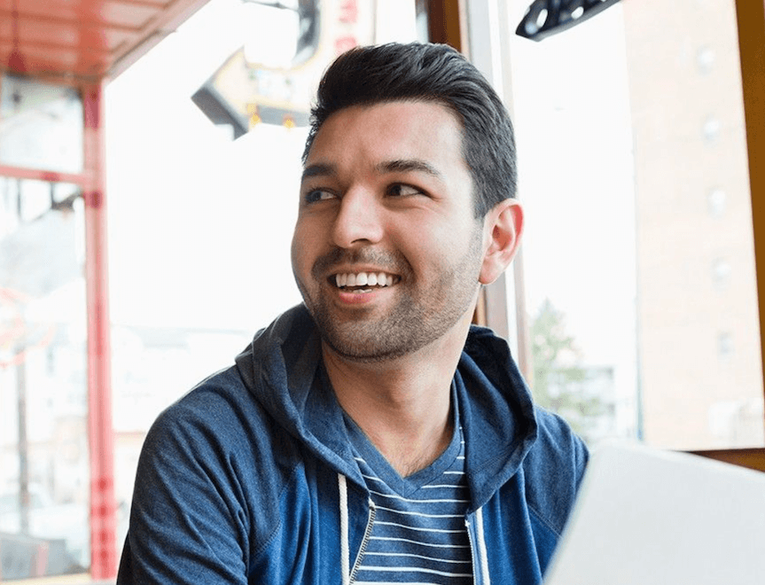 Man in jacket by his computer